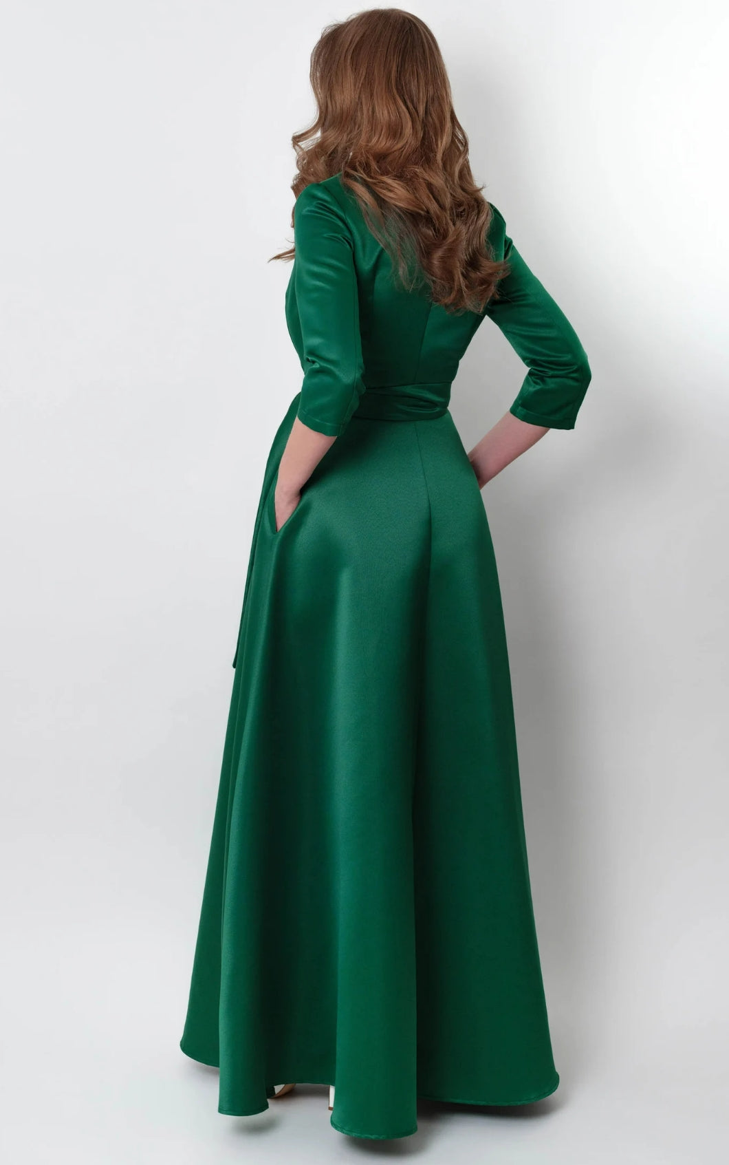 Side view of a woman wearing a formal satin A-line dress.