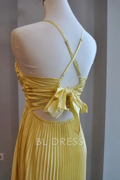 Yellow A-line V-neck pleated dress, side view.