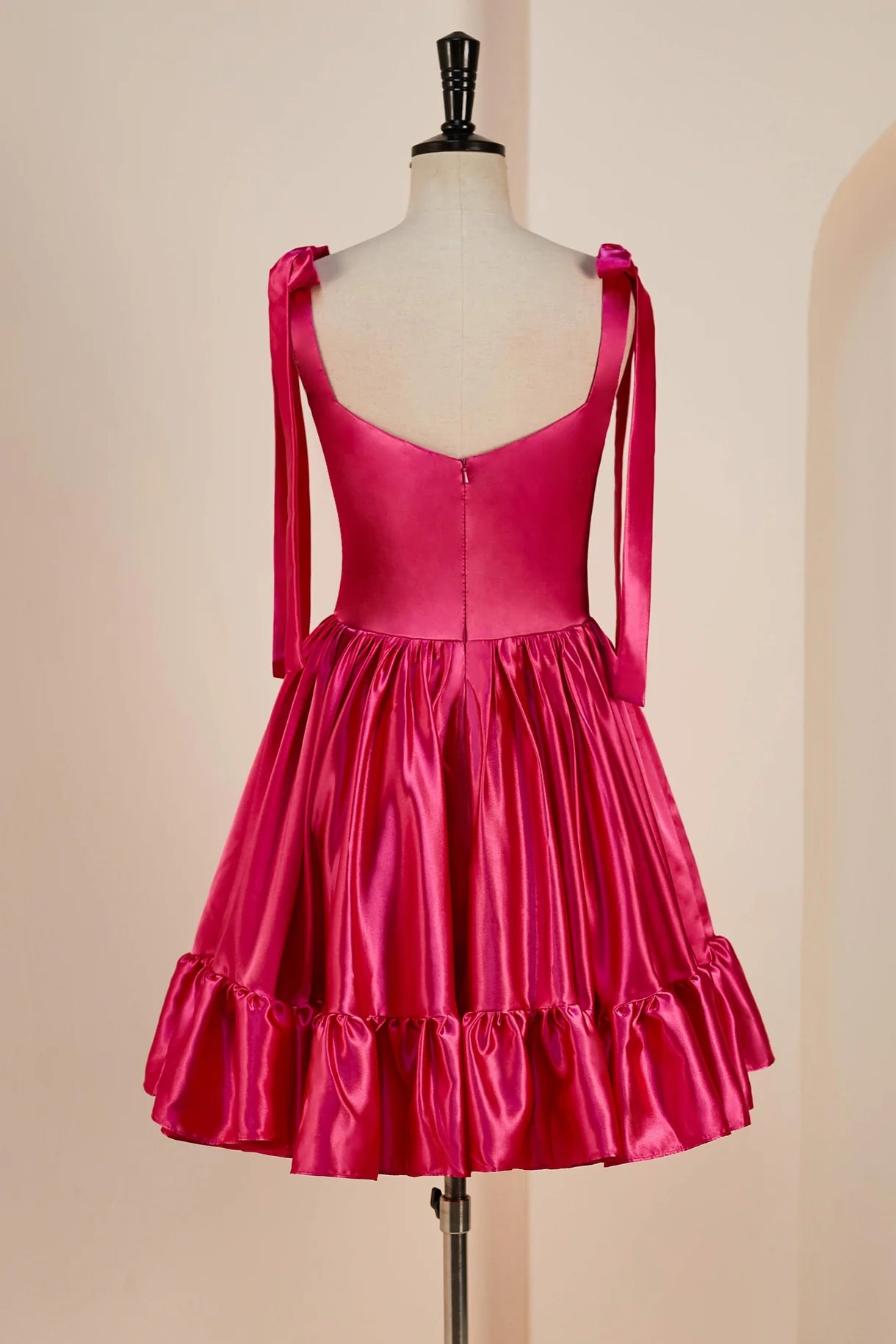 Back view of a light blue A-line homecoming dress, showing ruffled skirt and V-neck.