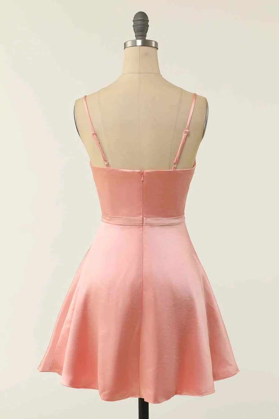 Side view of the black A-line V-neck mini dress, showing the twist knot and cut-out.
