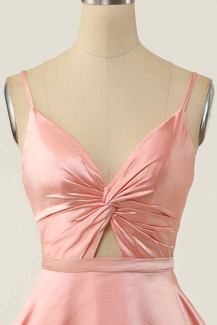 Close-up of the V-neck and twist knot cut-out detail on the black mini dress.