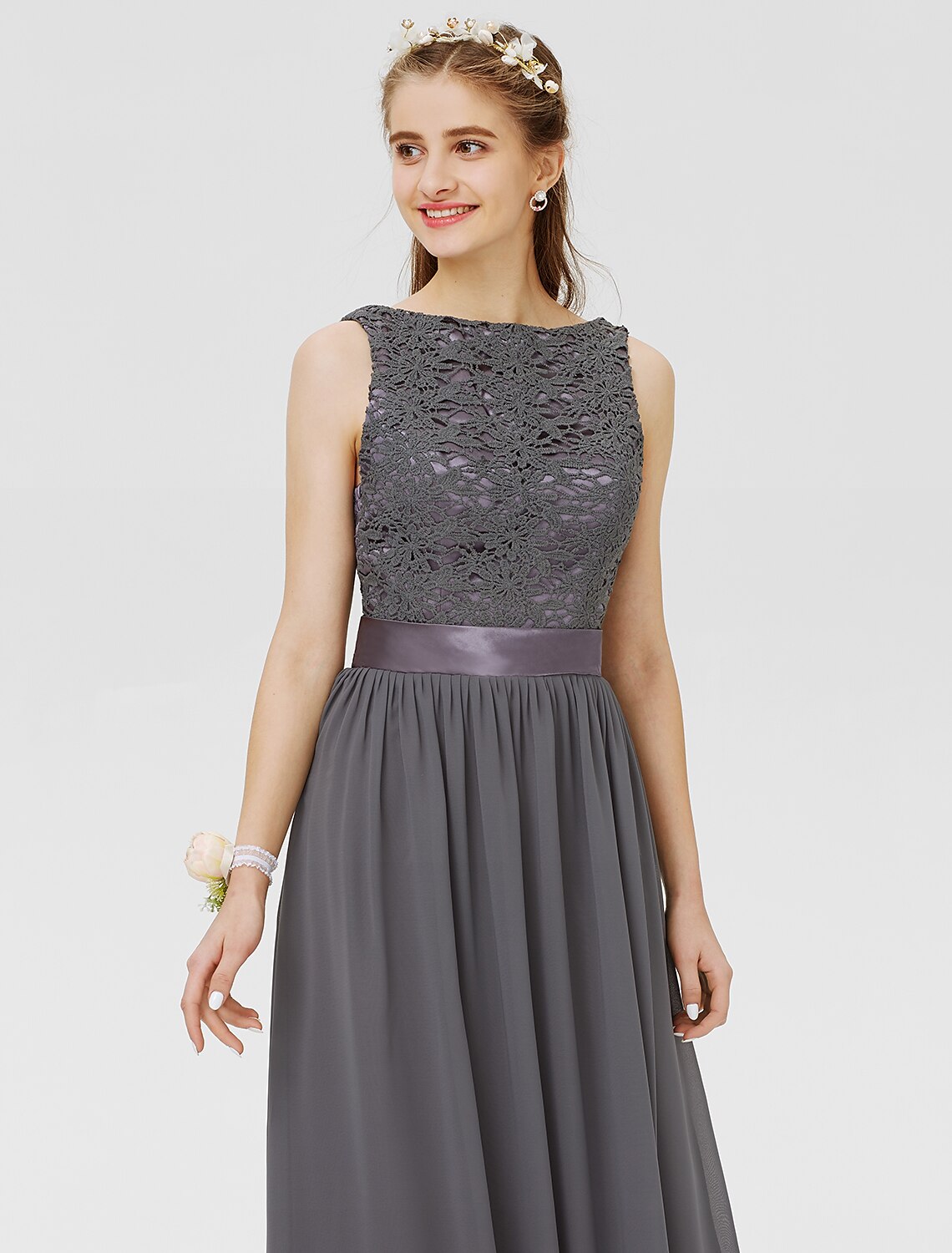 Detail of the pleated chiffon and sash on the floor-length bridesmaid gown.
