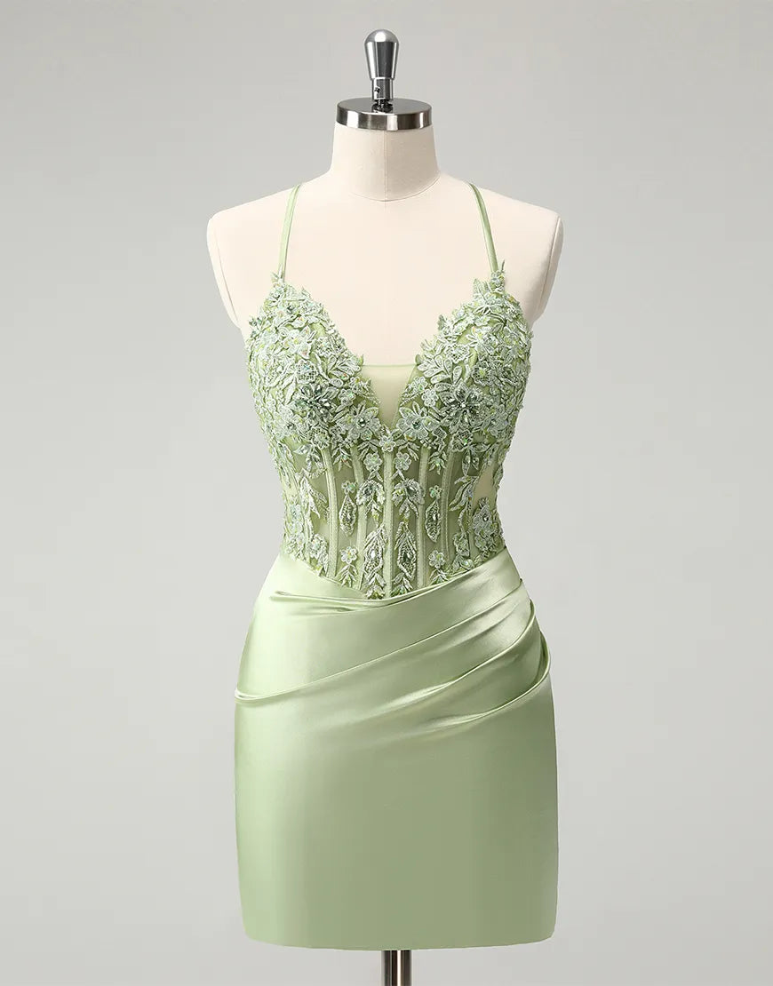 Model wearing a green beaded V-neck sheath dress with appliques.