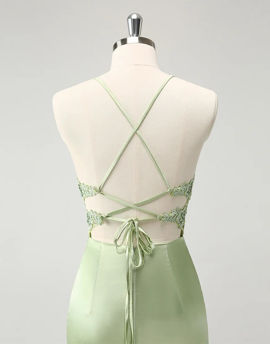 Close-up of appliques and beading on a green dress.