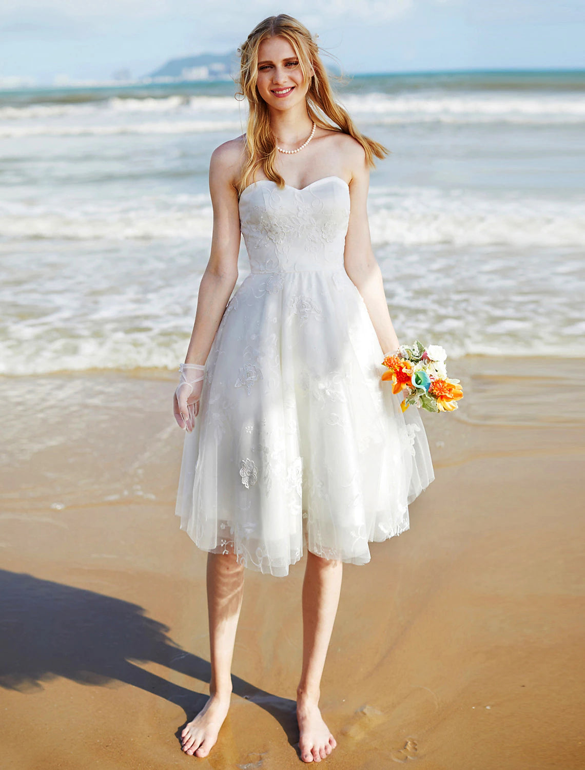Full view of a boho A-line sweetheart strapless knee-length lace wedding dress.