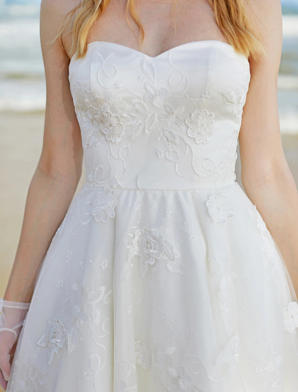 Close-up of delicate lace fabric on a boho wedding dress.
