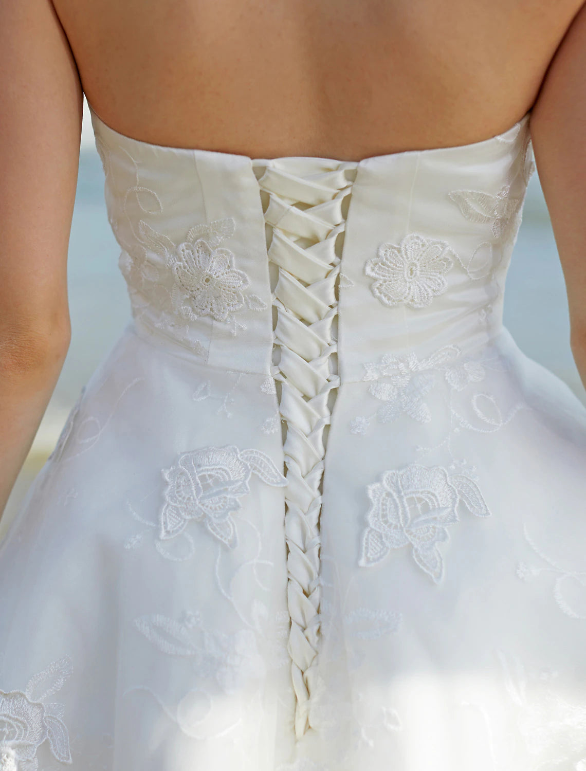 Model posing in a chic boho A-line sweetheart strapless wedding dress.