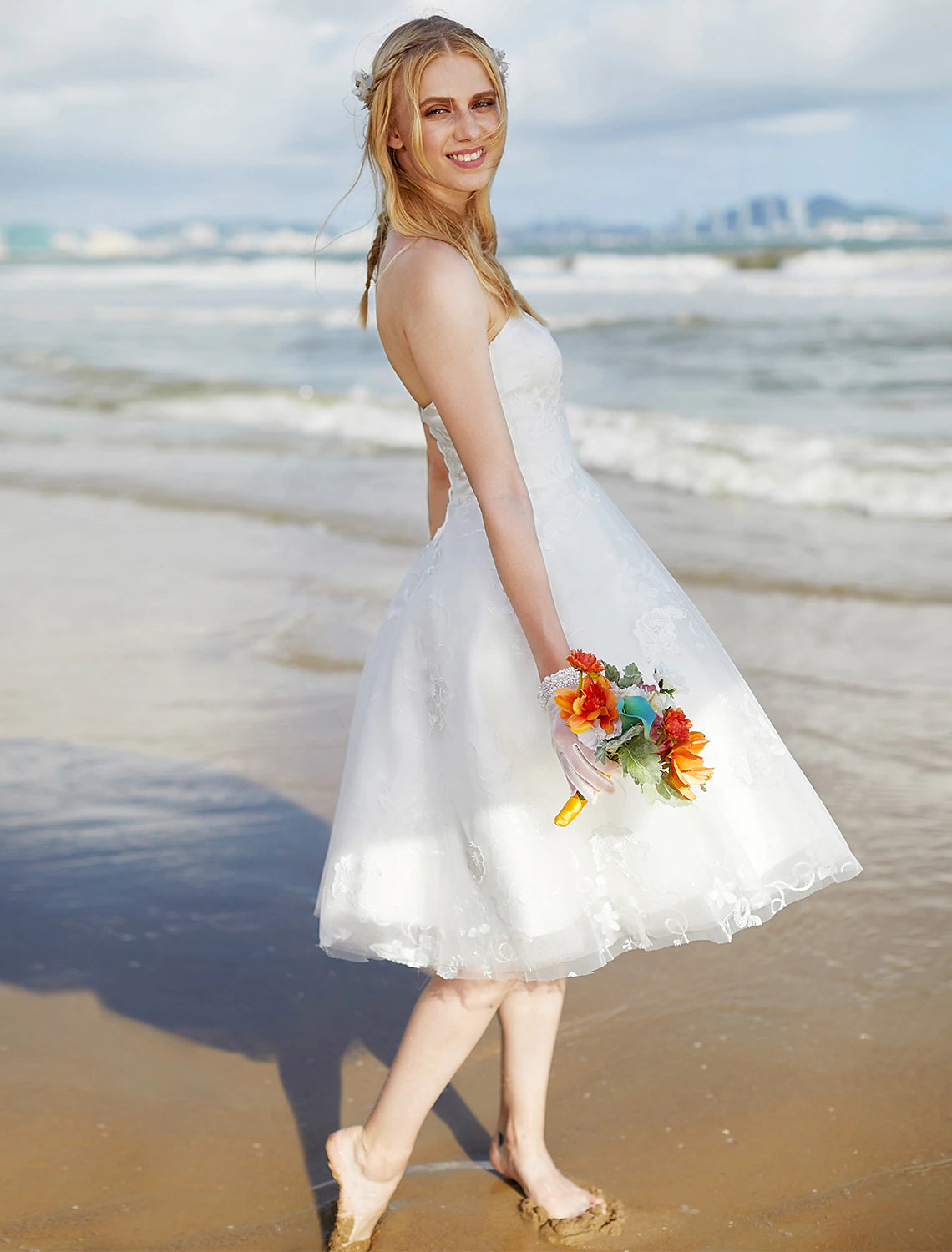 Elegant boho knee-length wedding dress with a sweetheart neckline and lace overlay.