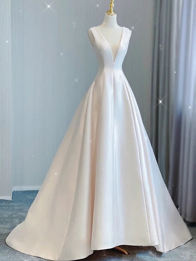 Full view of an elegant A-line satin wedding dress with V-neck, bows, and court train.