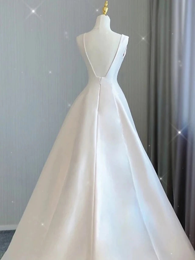 Back view of the A-line satin wedding dress showing the court train and pleats.