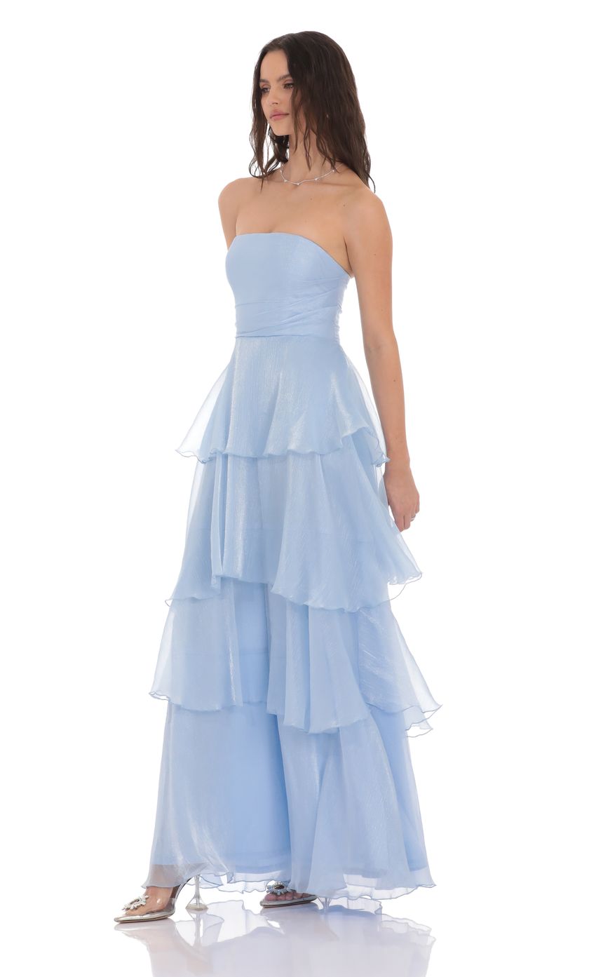 Back view of a model wearing the elegant sky blue strapless A-line maxi dress.