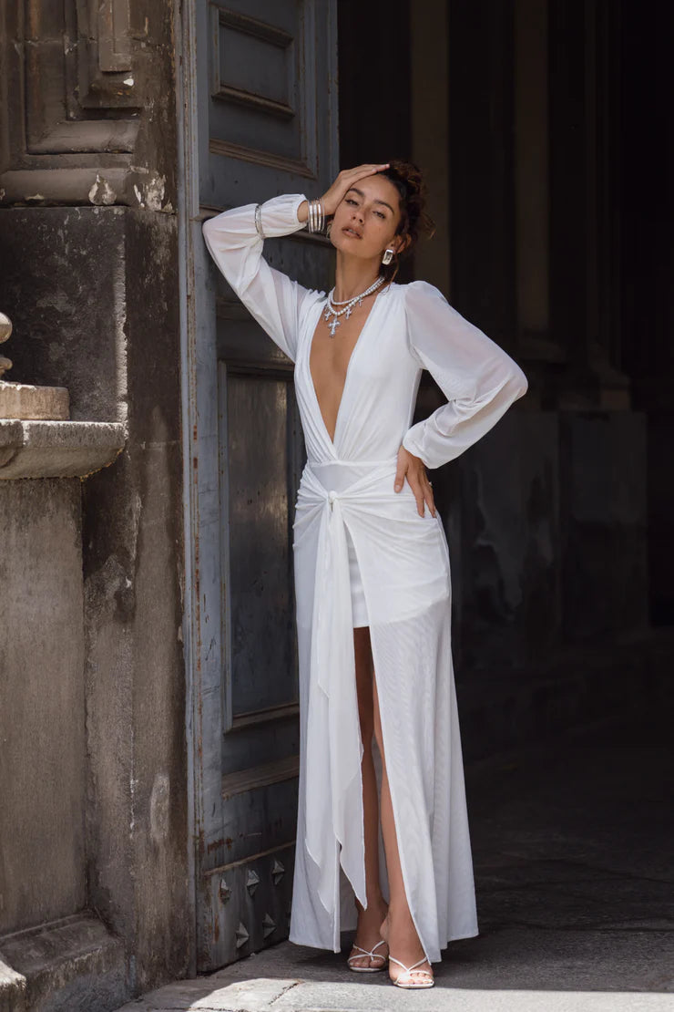 Model posing in a chic white mesh plunge V-neck maxi dress.
