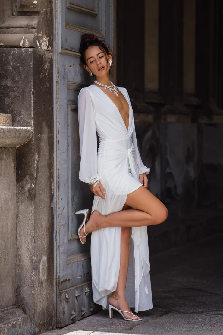 Side view of a model wearing the elegant white A-line prom dress.