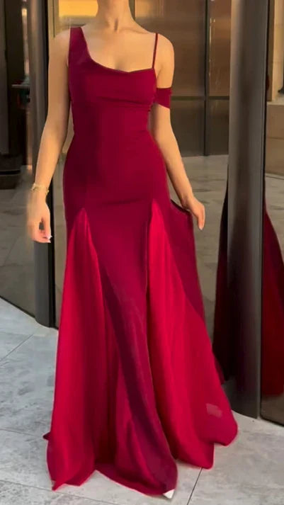 Woman wearing a dark slim-fit V-neck patchwork maxi dress.