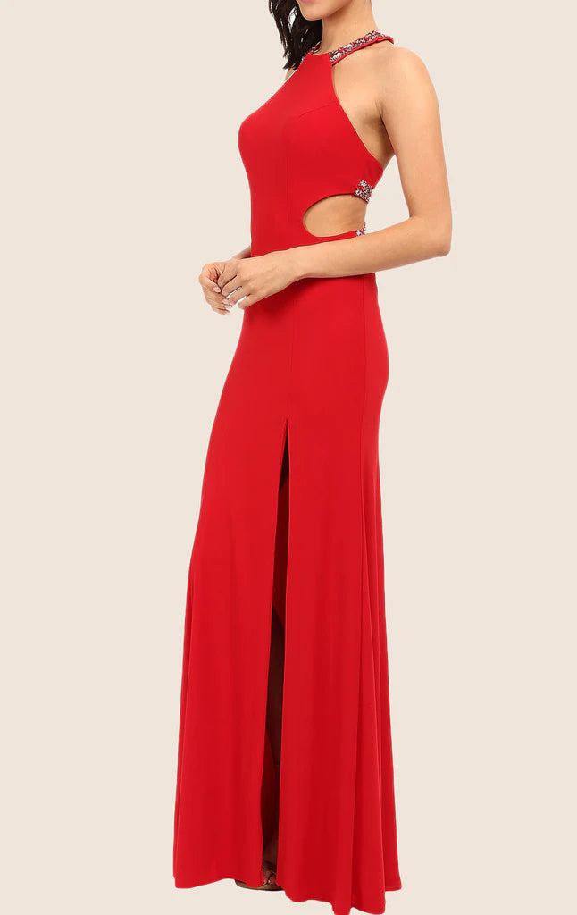 Woman posing in a chic halter maxi gown, showing the flowing skirt.