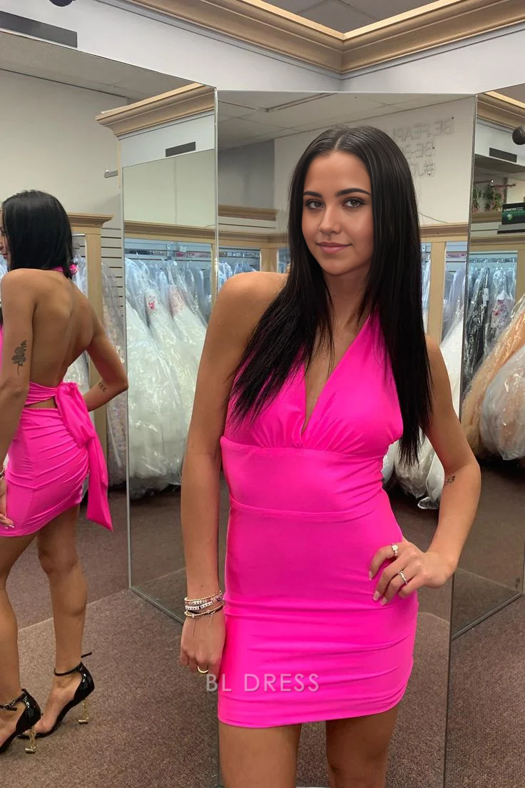 Model wearing a hot pink sheath V-neck short dress, front view.