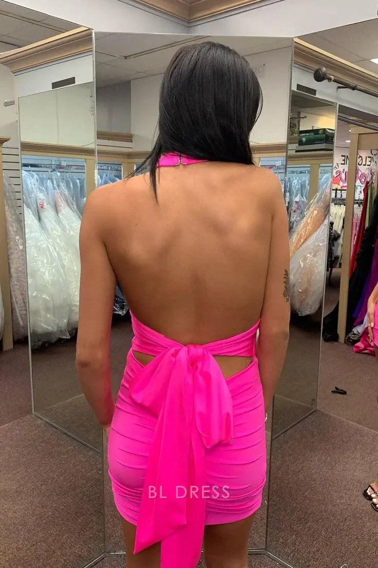 Model in a hot pink V-neck sheath dress, showcasing the back.