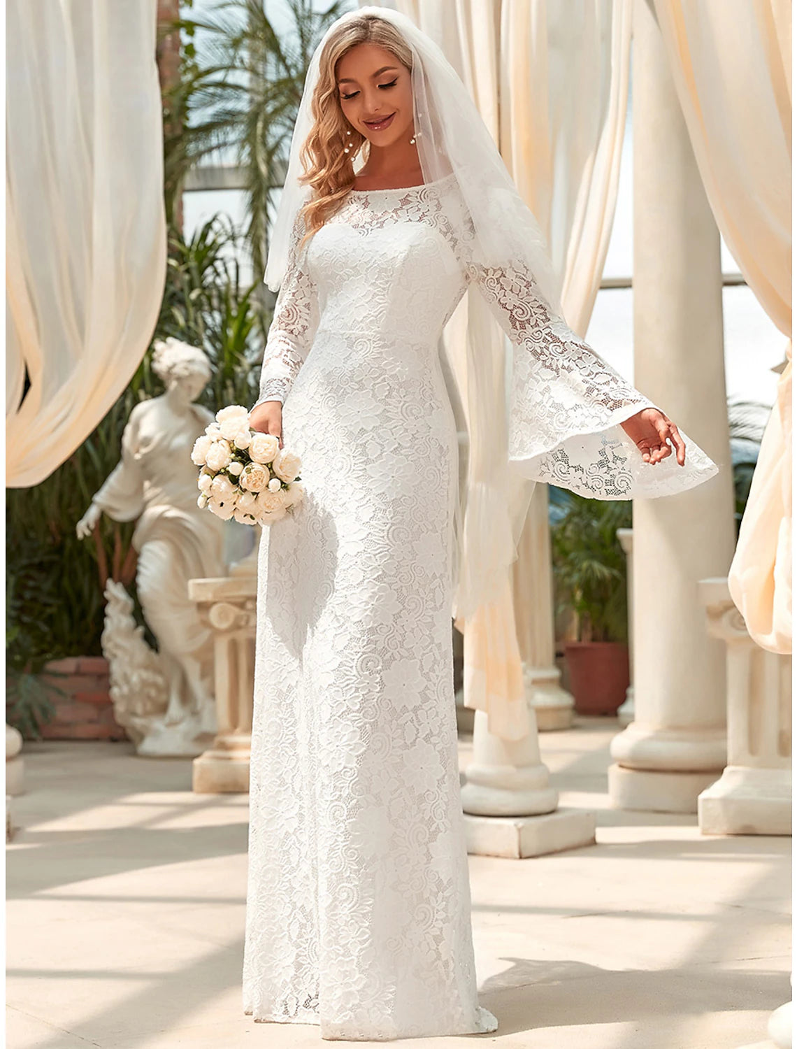 Back view of the white lace bridal gown, showcasing the mermaid silhouette.