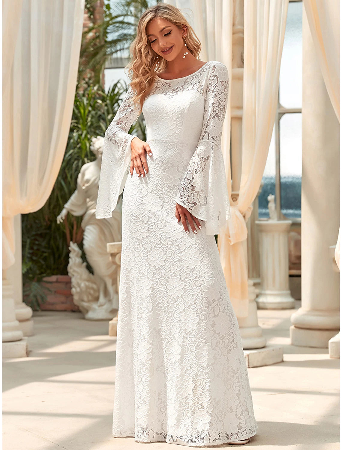 Close-up of intricate lace detailing on the long sleeve of the wedding dress.