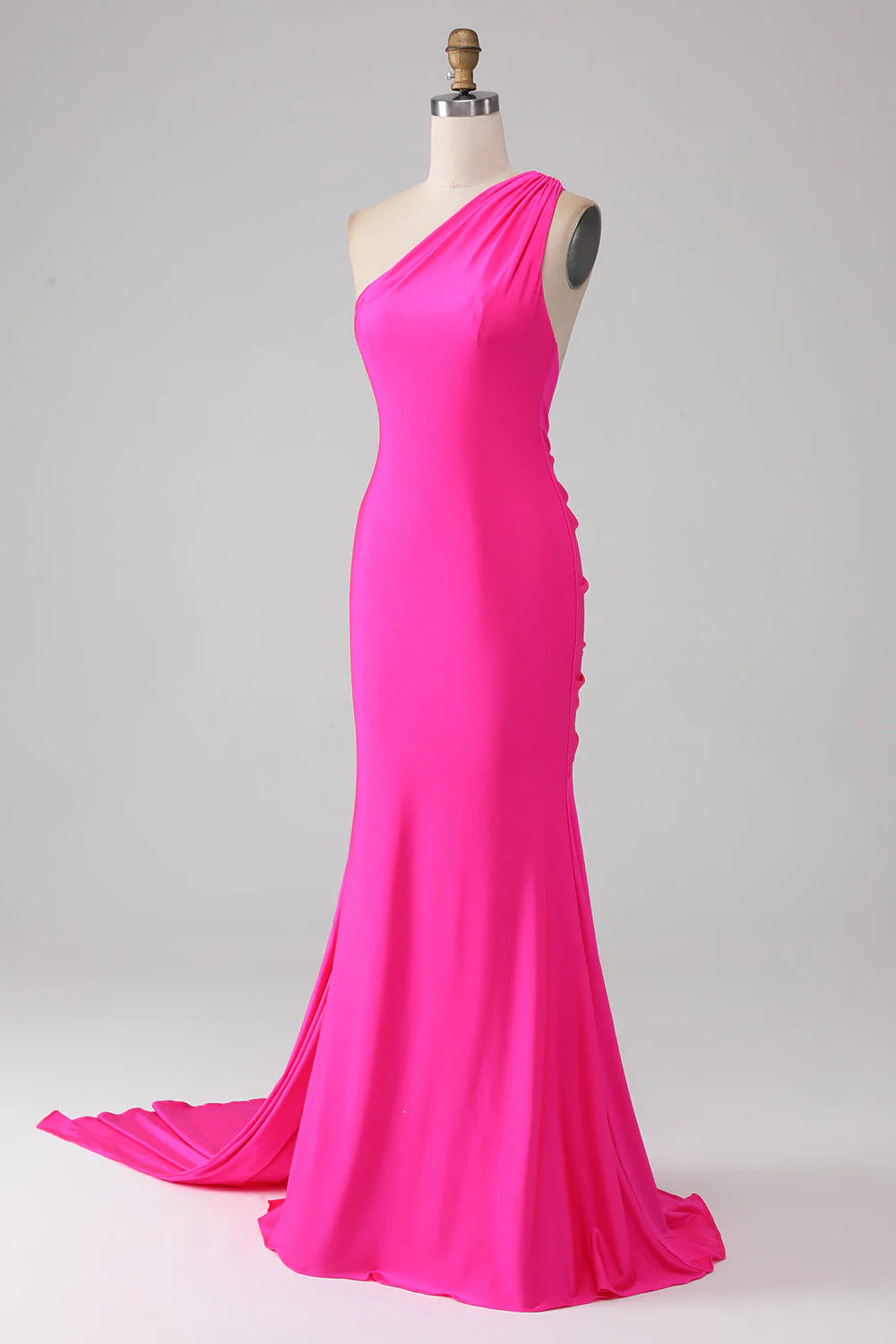 Side view of hot pink mermaid one-shoulder long prom dress.