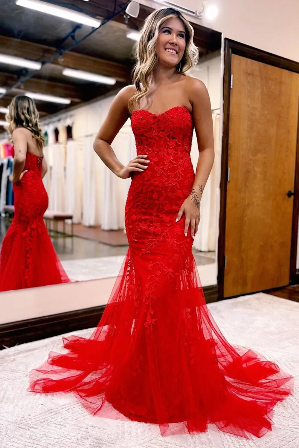 Elegant mermaid prom gown with sweetheart neckline and intricate appliques.