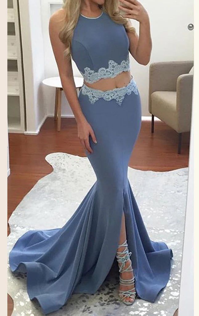 Front view of a model wearing a navy blue two-piece mermaid prom dress.