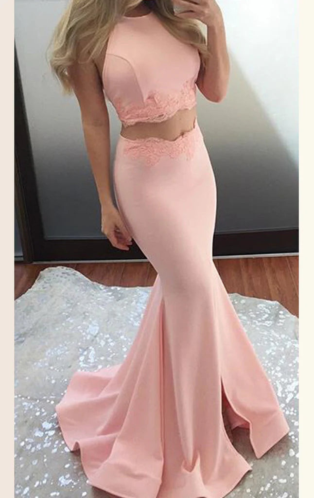 Back view of a model wearing a navy blue two-piece mermaid prom dress.