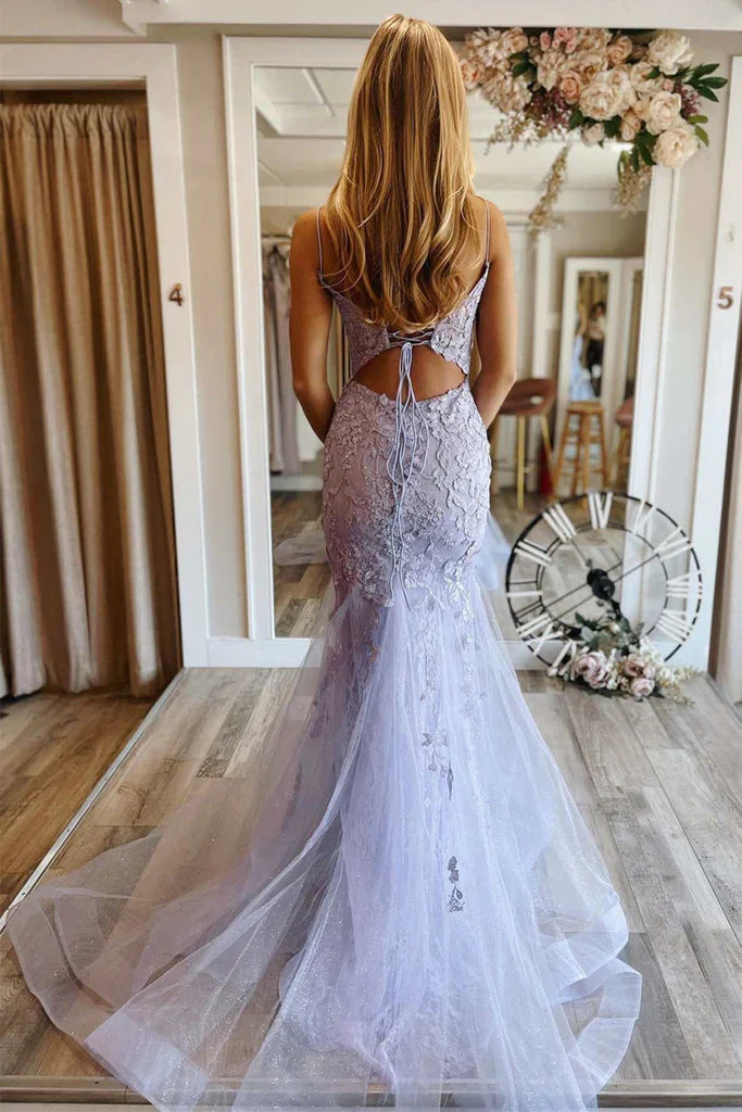 Close-up of lace floral details on a dark blue mermaid V-neck prom dress.