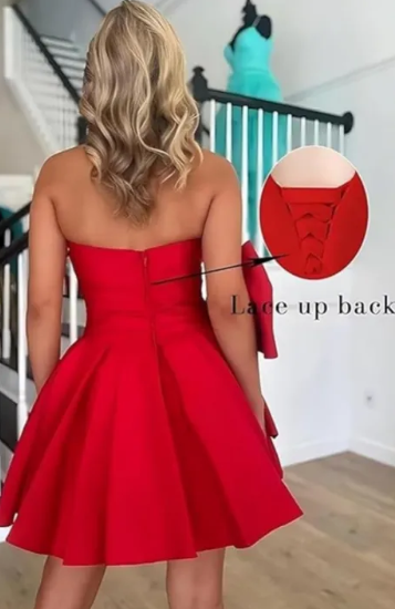 Model posing in the elegant short A-line strapless ruched ruffle dress.