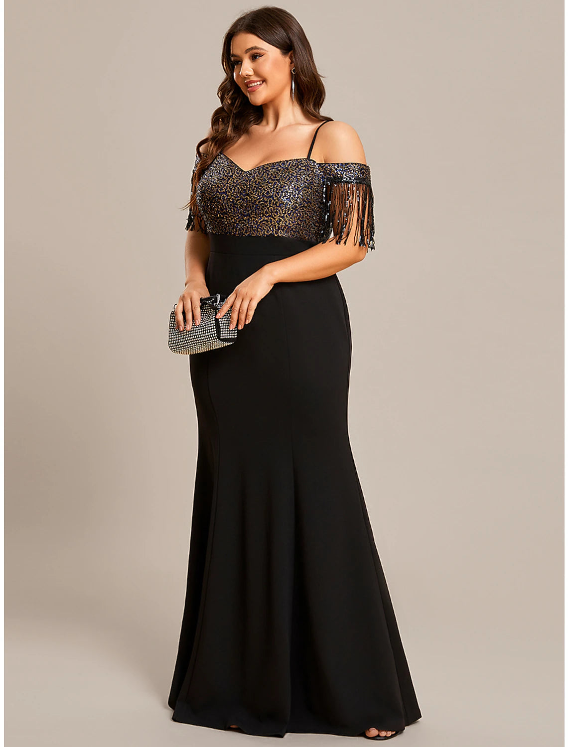 Close-up of the fringe tassel detail on the off-shoulder formal dress.