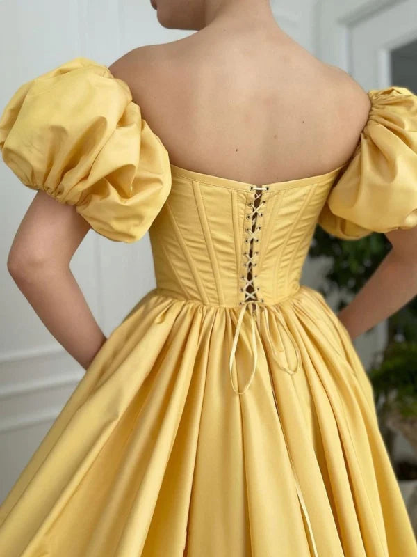 Model showcasing the high slit and flowing silhouette of the satin off-shoulder gown.