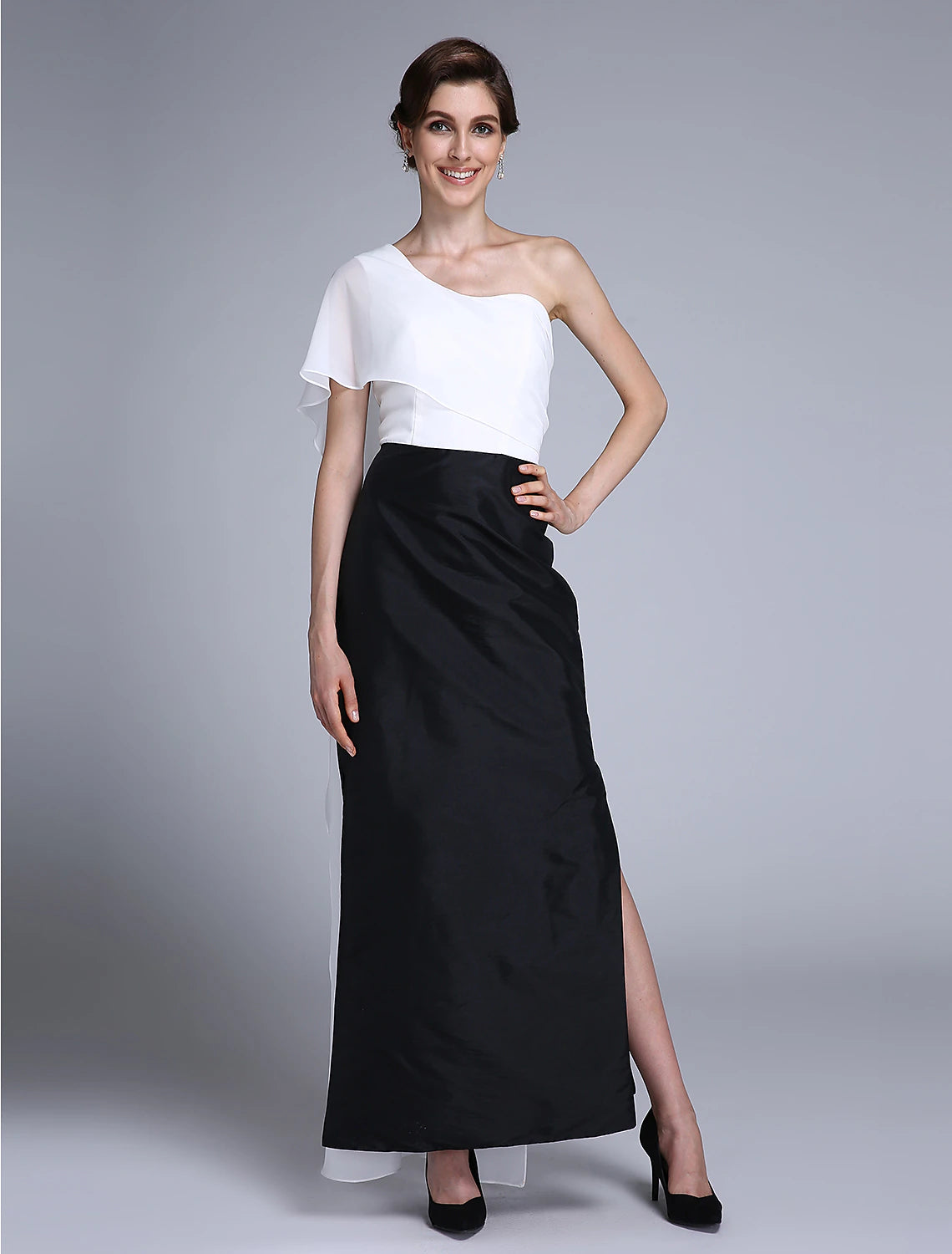 Woman wearing a blue and black color block one-shoulder mermaid trumpet dress with a split front.