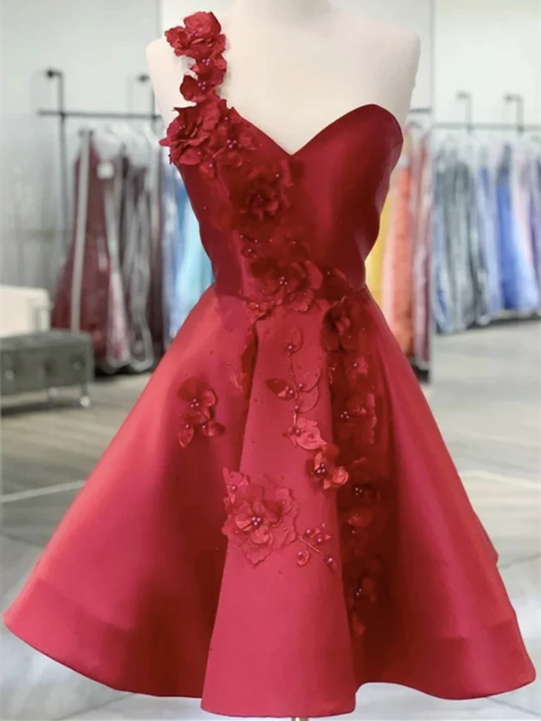 Woman wearing a chic one-shoulder satin short backless homecoming dress.