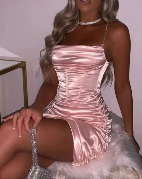 Pink pleated sheath cocktail dress with spaghetti straps.