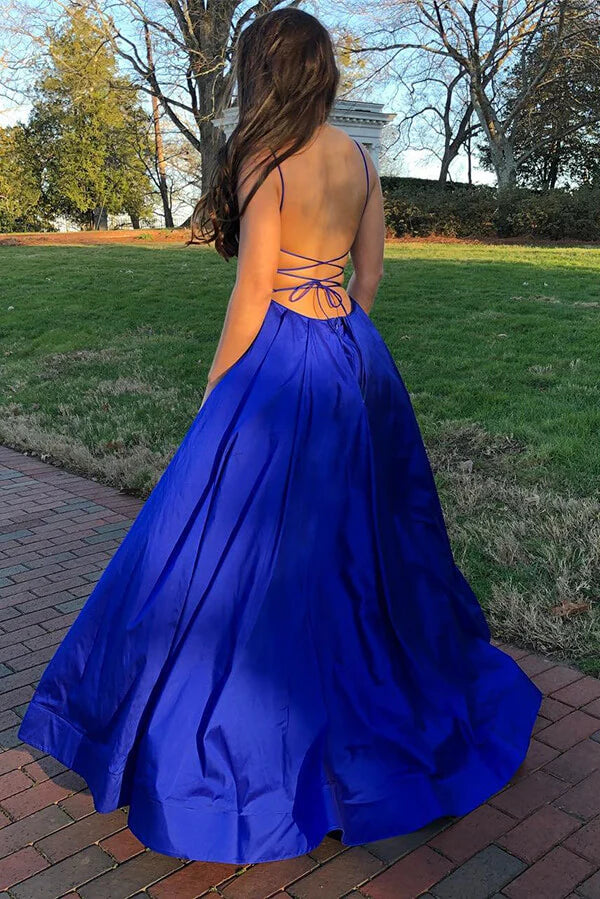 Back view of a royal blue A-line satin prom dress with spaghetti straps.