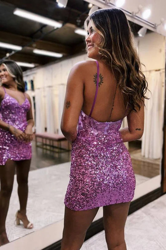 Close-up of the sequined sweetheart neckline and ruched sheer tulle on the mini dress.