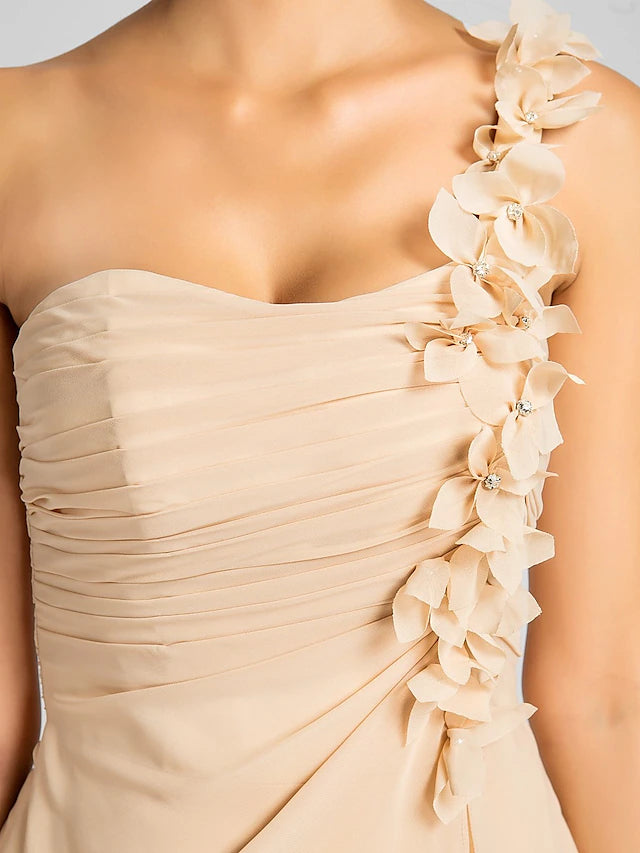 Model posing in a one-shoulder knee-length chiffon dress.