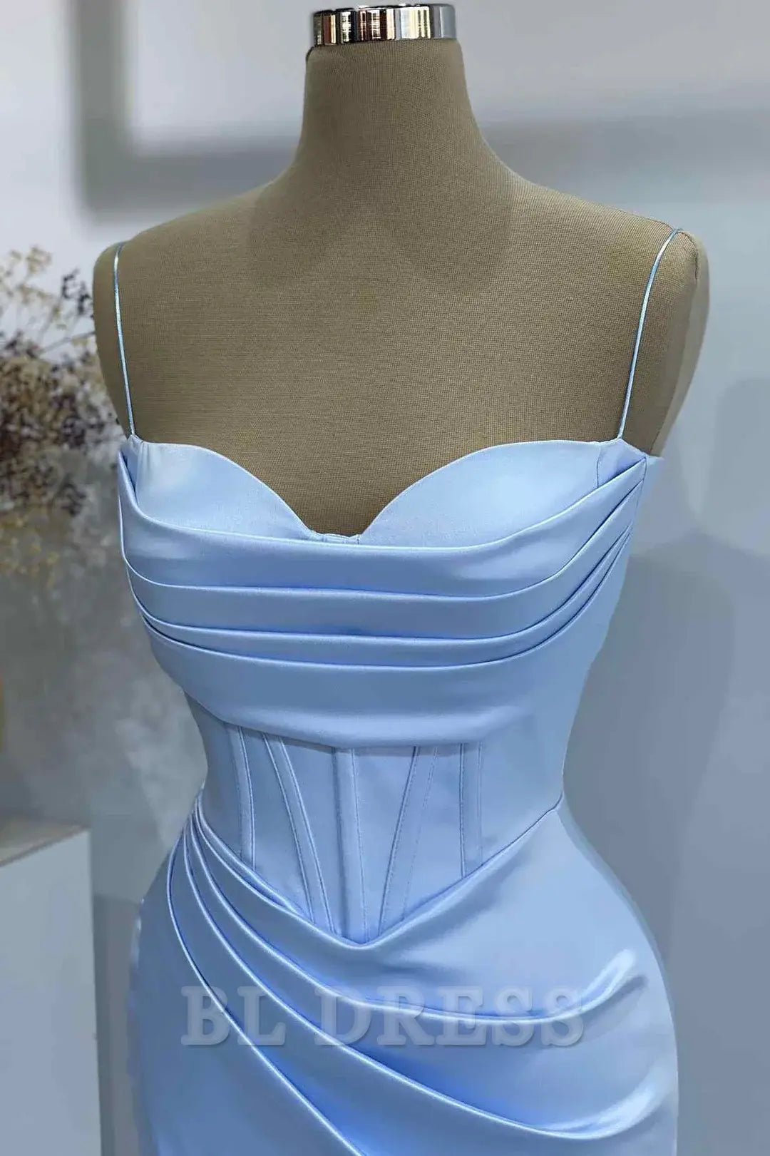 Full view of the light blue satin pleated formal dress.