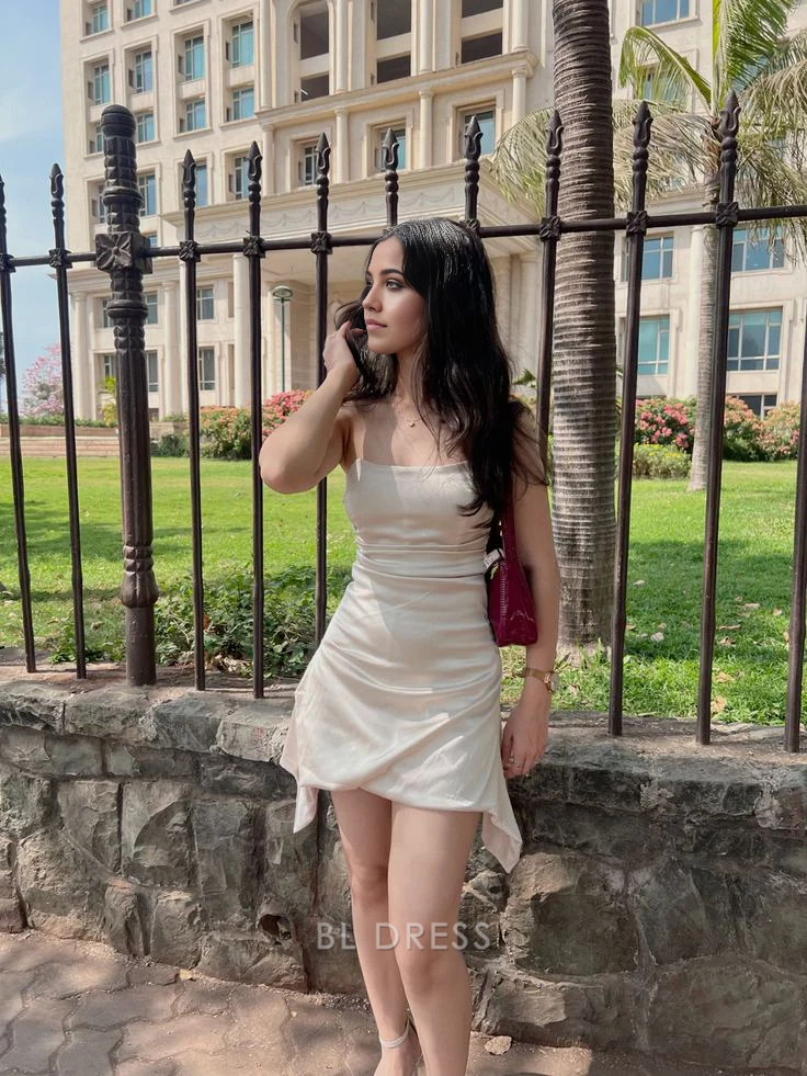 Woman wearing a short strapless satin sheath dress.