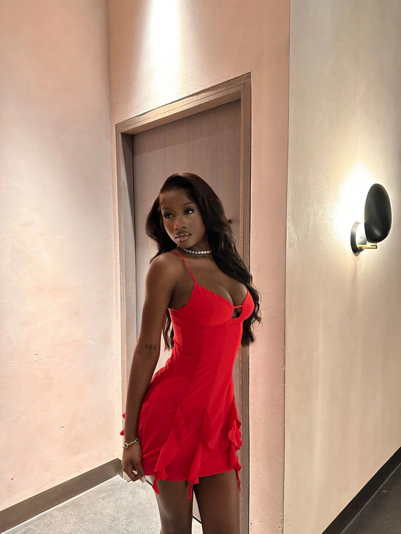 Close-up of the sweetheart neckline and bust cutout on the red dress.