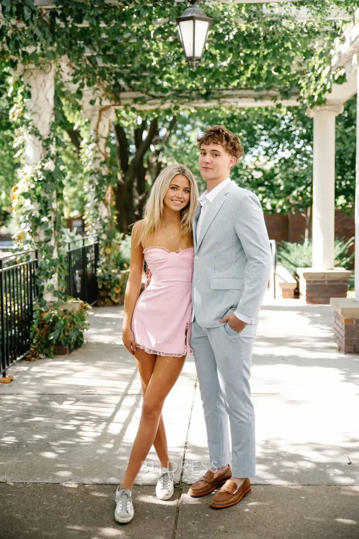 Model wearing a pink short sheath dress with a sweetheart neckline and a thigh-high slit.