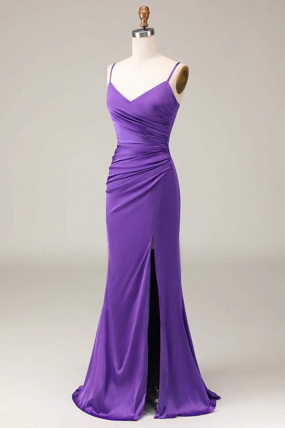 Woman posing in a chic satin sheath dress, highlighting the V-neck and slit.