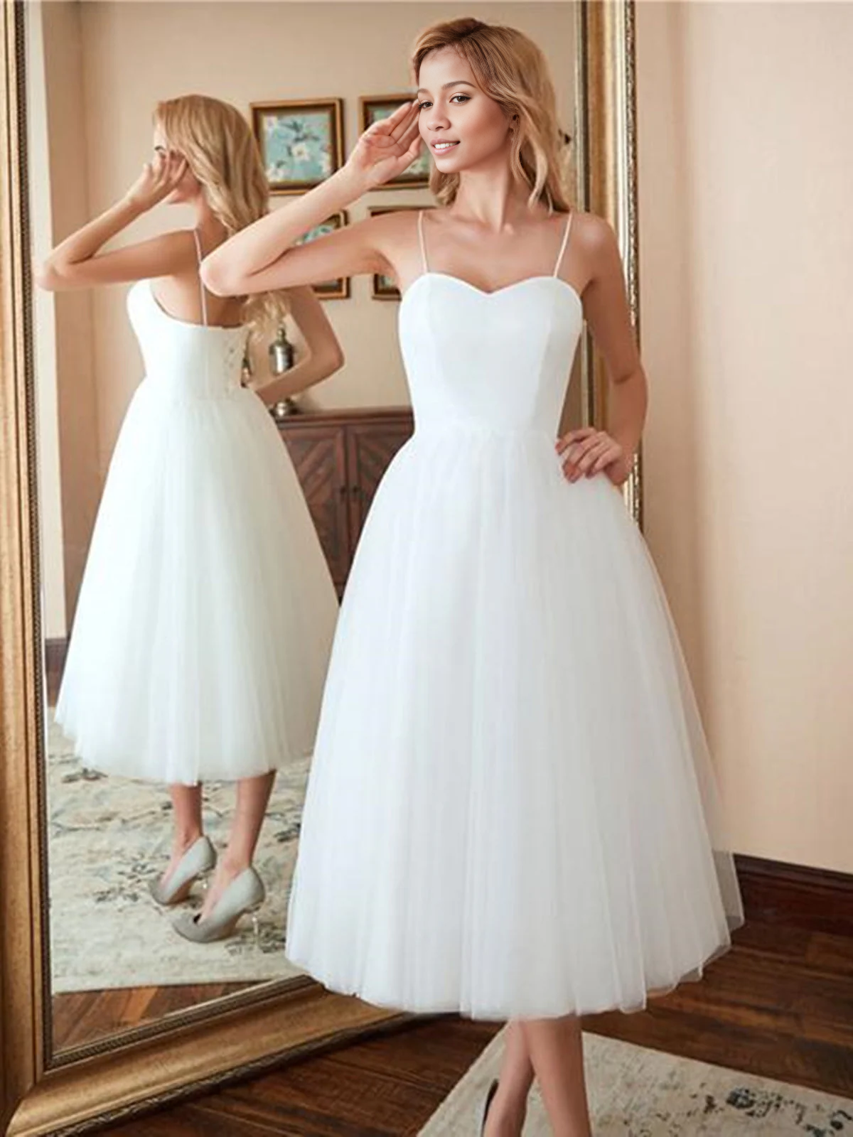 Back view of an A-line sweetheart tulle tea length wedding dress.