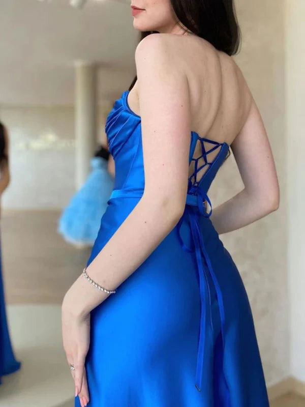 Elegant sleeveless prom gown with an open back and a side slit.
