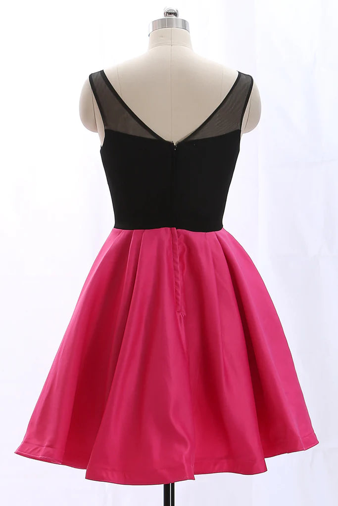 Model posing in a black mini prom dress with spaghetti straps.