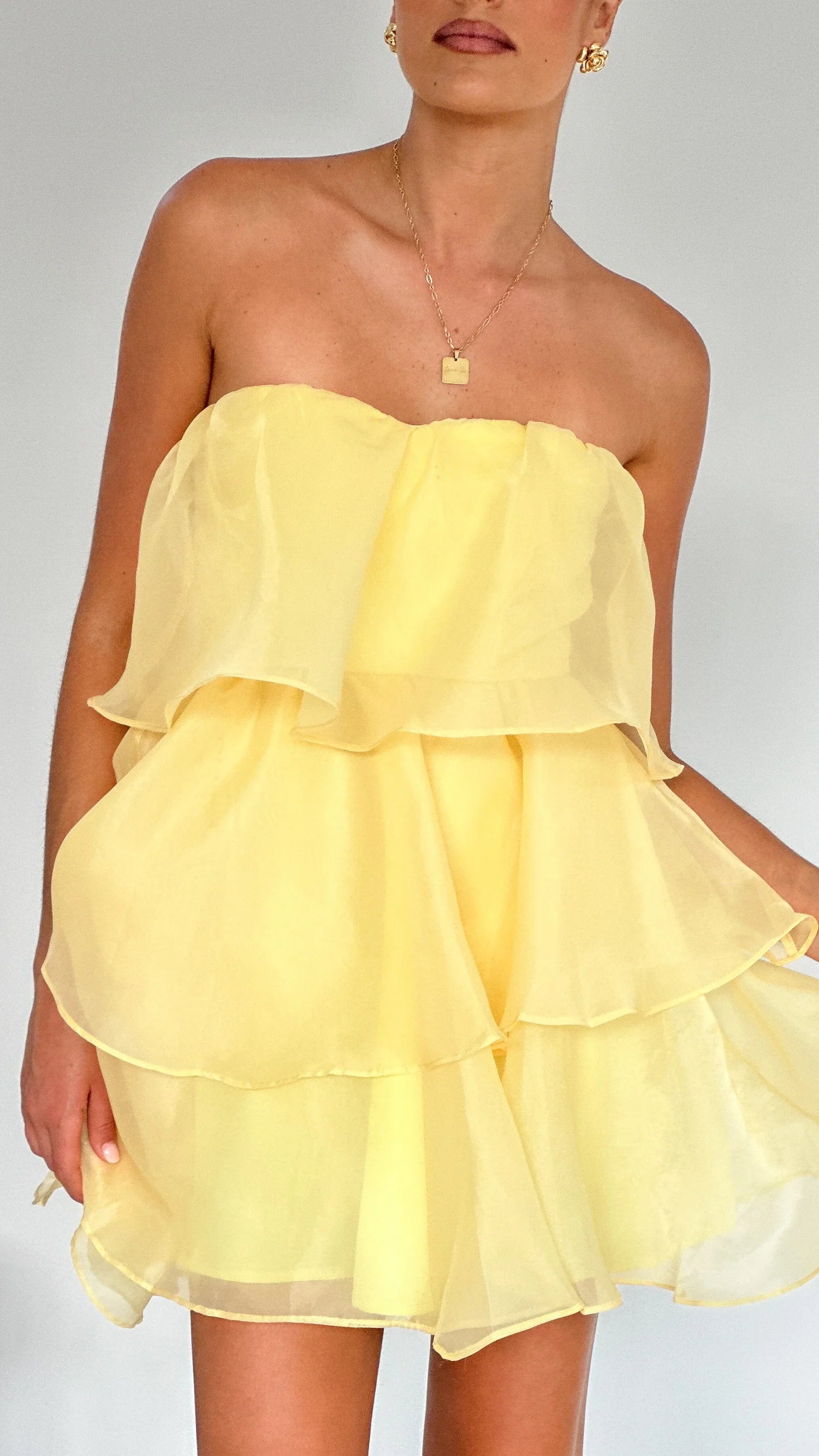 Backless design of the strapless mini dress.