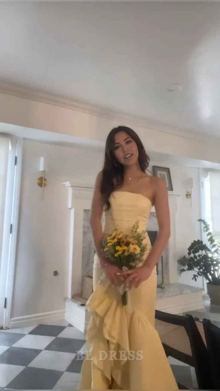 Yellow strapless mermaid formal dress with ruffle details.