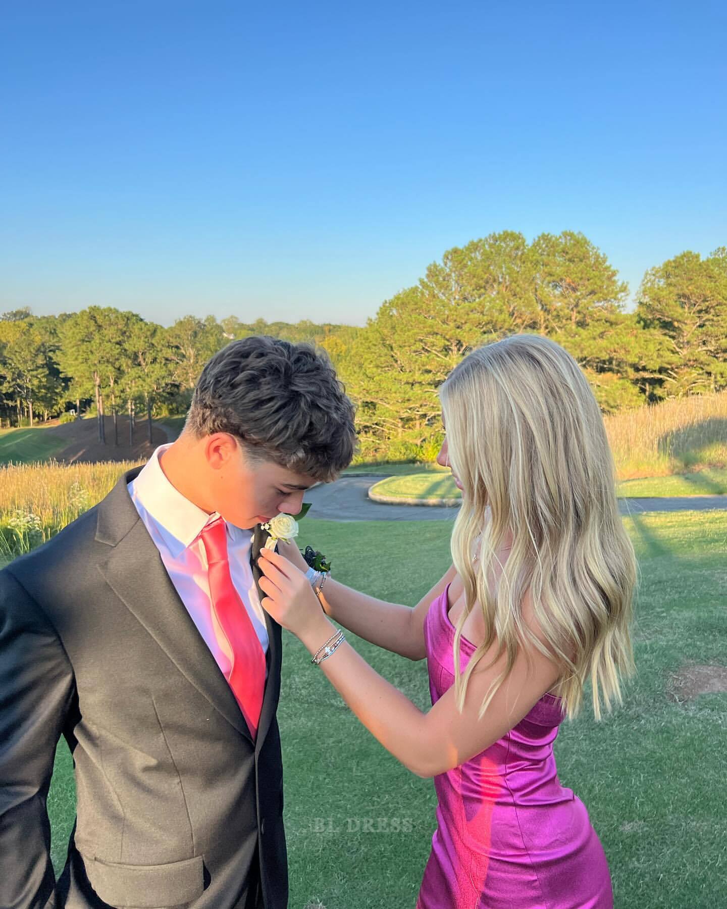 Back view of a chic pink satin strapless bridesmaid or prom dress.