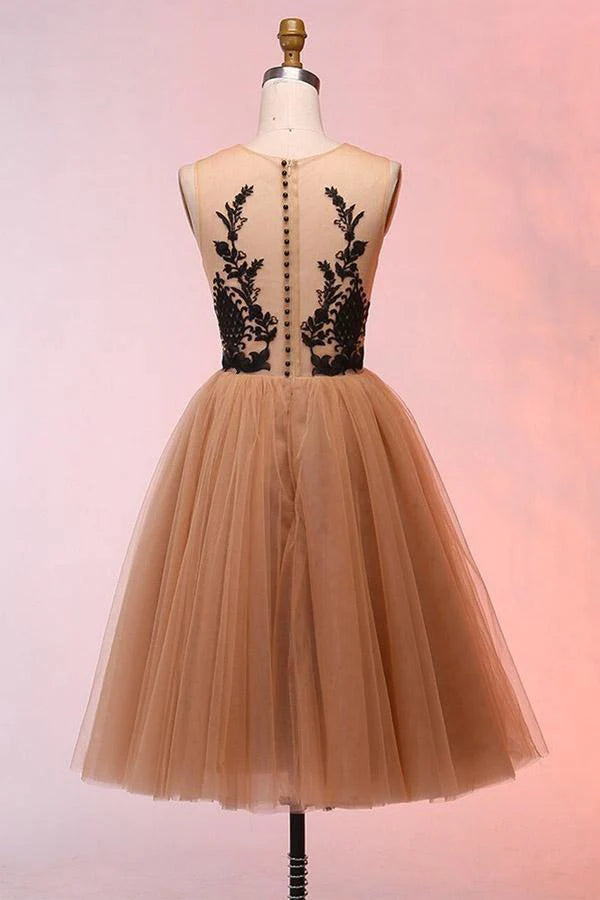 Model wearing a short A-line tulle dress with appliques, suitable for homecoming.