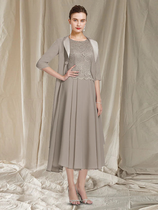 Full view of the two-piece A-line Mother of the Bride dress with jewel neck and half-sleeve jacket.